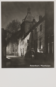 130485 Gezicht in de Muurhuizen te Amersfoort, met de Dieventoren (Muurhuizen 97), bij avond.